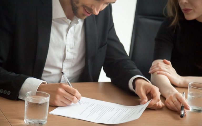 satisfied smiling businessman suit signing contract meeting concept 1 1024x683 1 768x479